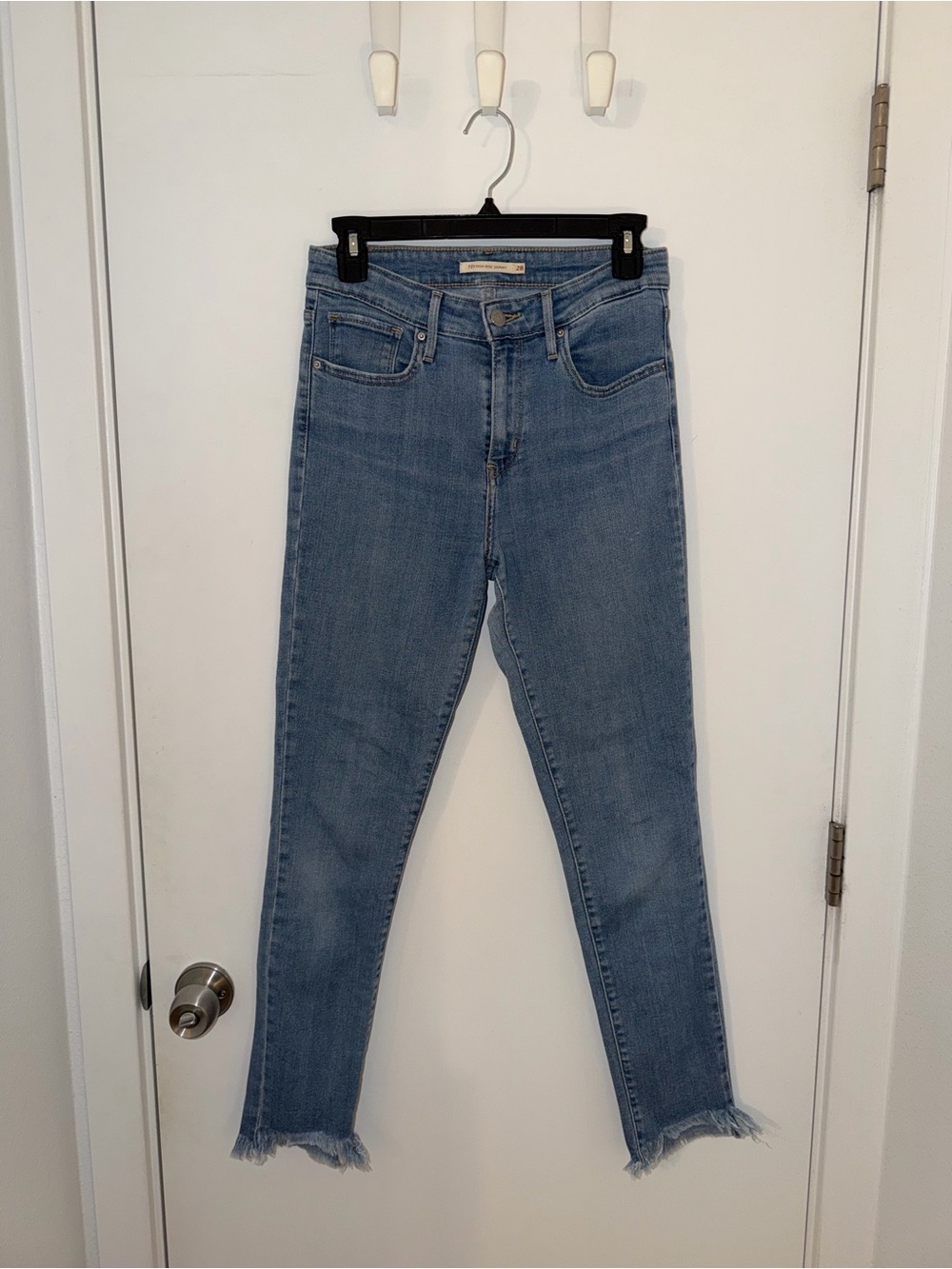 Levi's 721 - Light Blue Cropped High-Rise Skinny Jeans with Distressed Ankles